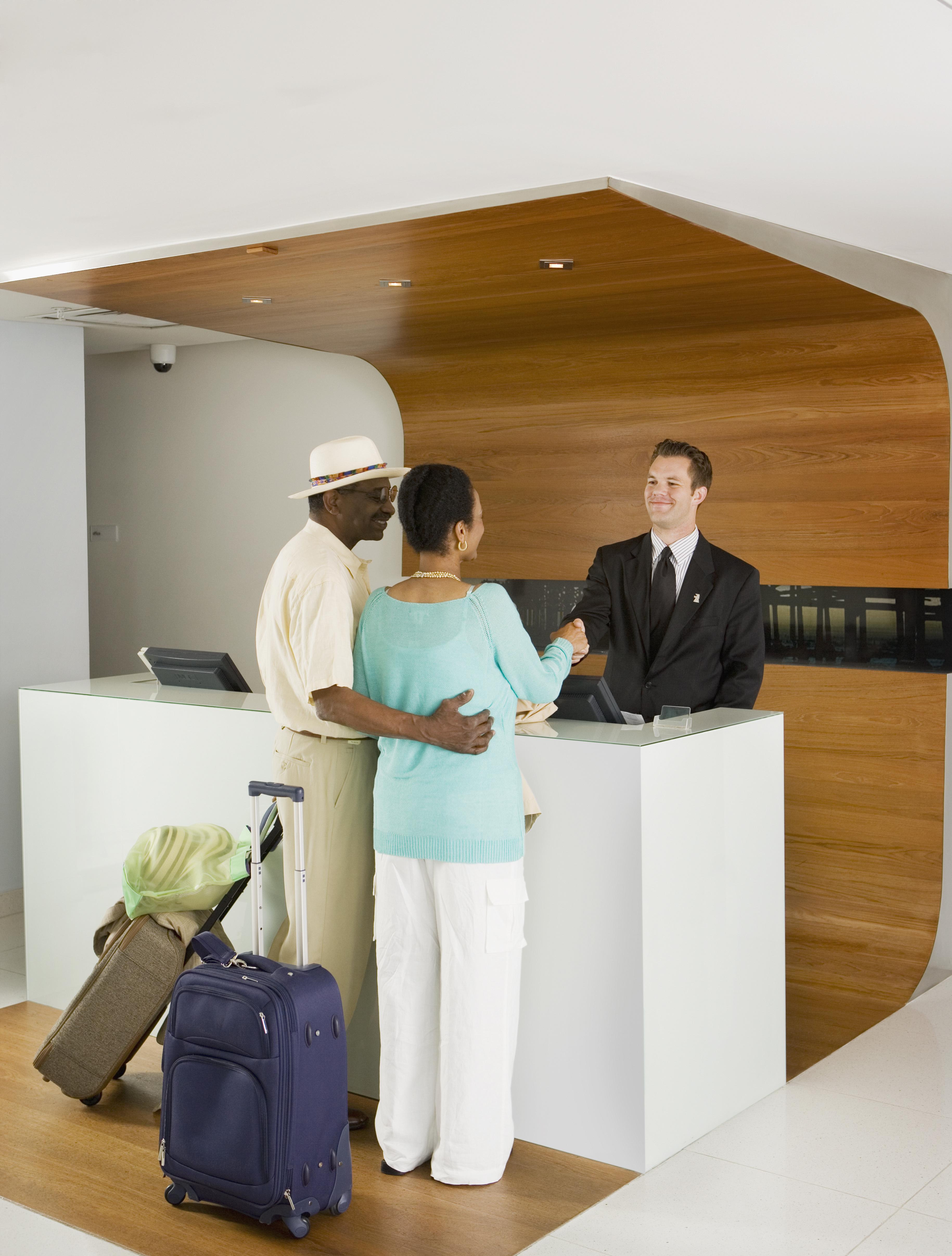 Senior African couple at hotel counter