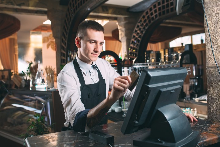 Restaurant server working with a point of sale system.